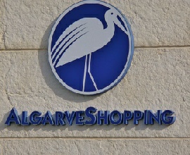 sign of Guia Algarve shopping center sign with a stork emblem