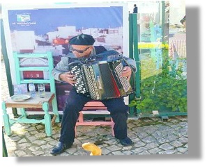 seated man wearing a beret playing an accordion